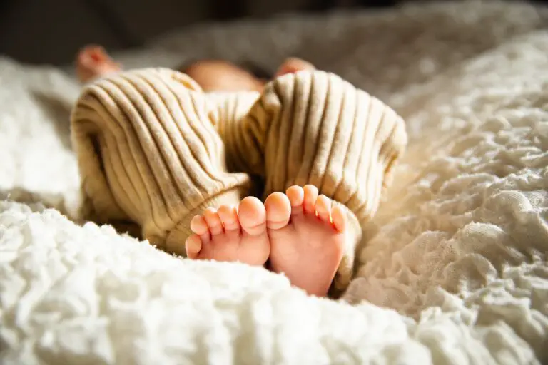 Anonymous baby sleeping closely observed for bed bugs