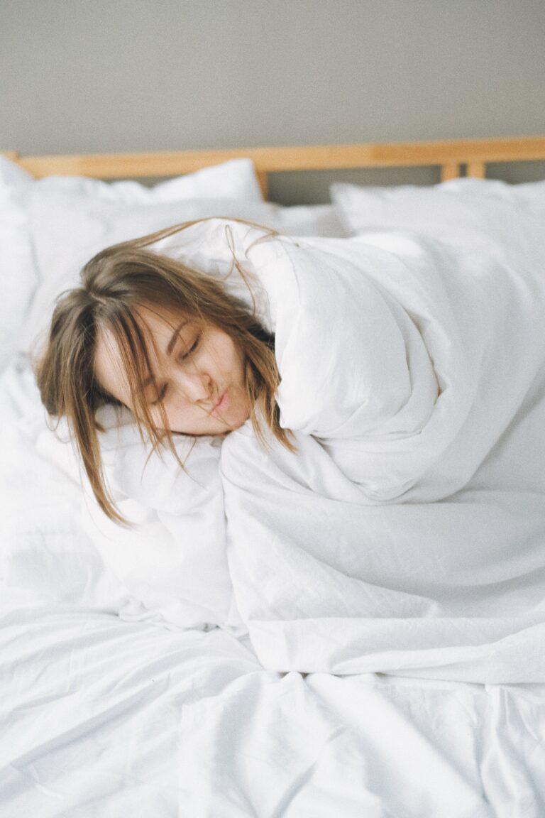 Bed bug flea bites on humans seen on Woman Covered in White Blanket Lying on Bed