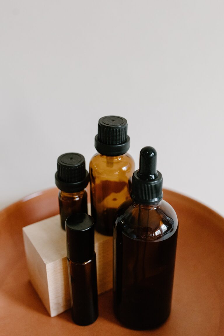 Peppermint oil repellent in an amber bottle against a wooden background